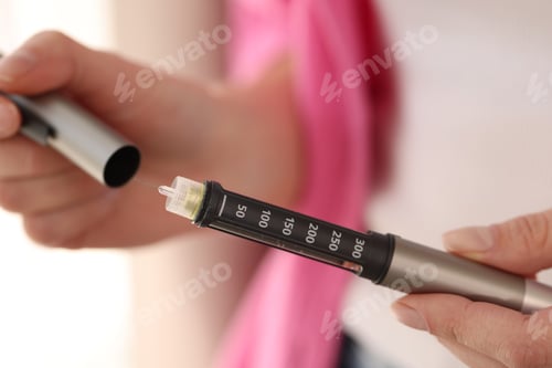 Preview: Diabetes. Woman with autoinjector at home, closeup