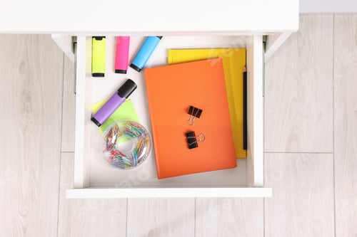 Preview: Different office stationery in open drawer indoors, top view