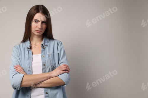 Preview: Portrait of resentful woman on light grey background, space for text