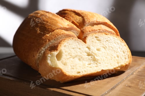 Preview: Pieces of fresh bread on wooden board, closeup