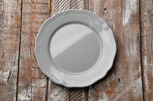 Preview: Empty plate on wooden table, top view