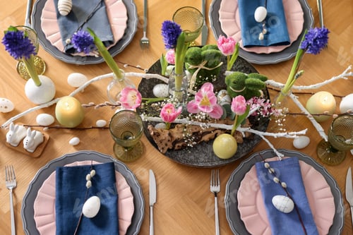 Preview: Easter celebration. Festive table setting with flowers and painted eggs indoors, flat lay