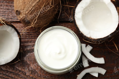 Preview: Tasty coconut yogurt in jar and fruits on wooden table, flat lay