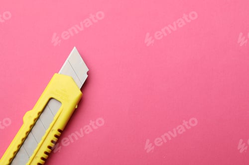 Preview: One sharp paper knife on pink background, top view. Space for text