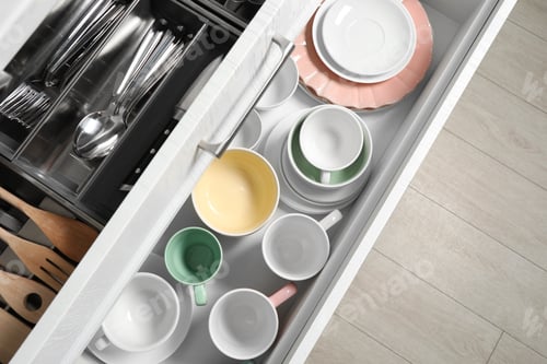 Preview: Ceramic dishware, utensils and cutlery in drawers, top view