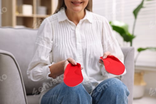 Preview: Senior woman with orthopedic insoles at home, closeup