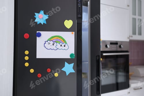 Preview: Refrigerator with child's drawing and magnets indoors, closeup