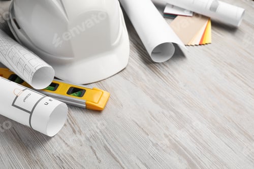 Preview: Building level and other construction tools on white wooden table, closeup. Space for text