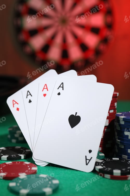 Preview: Casino chips and playing cards on green table, closeup