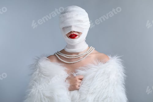 Preview: Woman with face wrapped in medical bandage after plastic surgery operation on grey background
