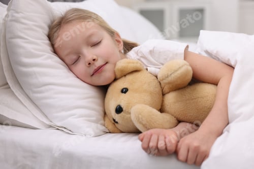 Preview: Cute little girl sleeping with her teddy bear on bed at home