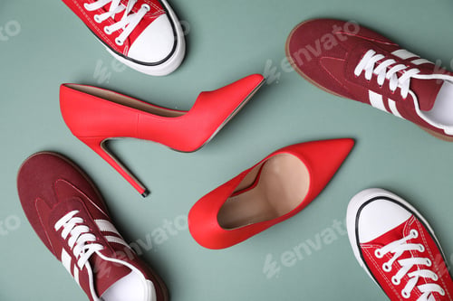 Preview: Different stylish shoes on color background, flat lay