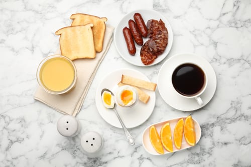 Preview: Tasty breakfast with soft boiled egg and toasted bread served on white marble table, flat lay