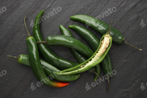 Preview: Green chili peppers on grey textured table, top view