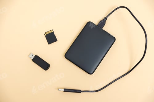Preview: Different modern storage devices on beige background, flat lay