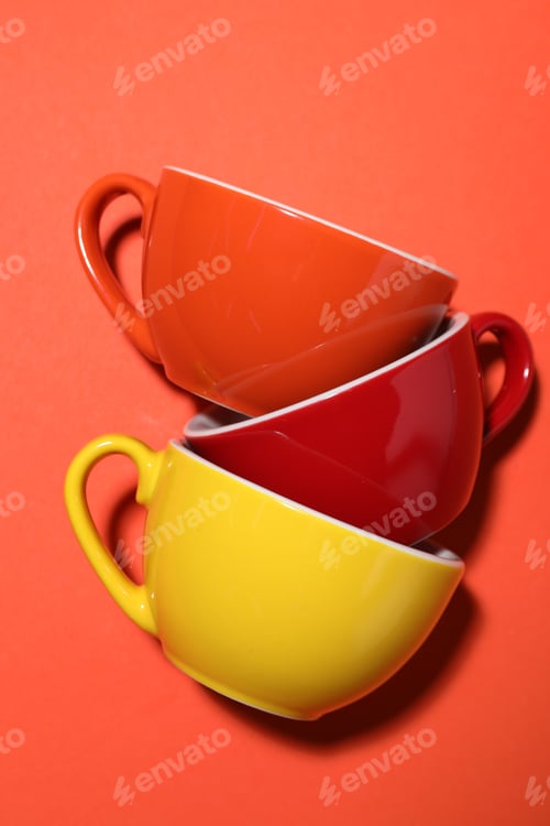 Preview: Different coffee cups on red background, flat lay