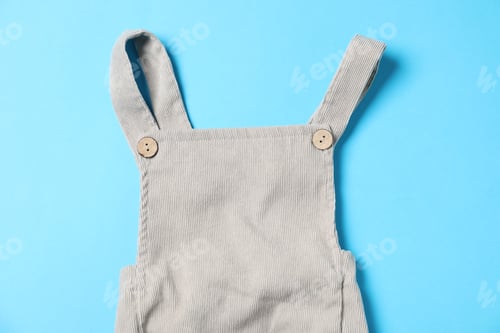 Preview: Baby overalls on light blue background, top view