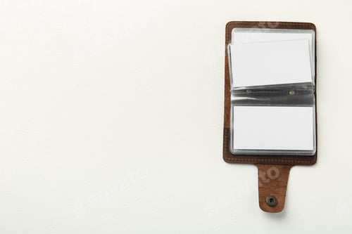 Preview: Leather business card holder with blank cards on white table, top view. Space for text