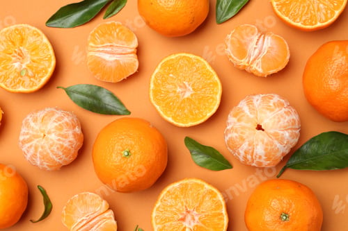Preview: Fresh tangerines and green leaves on orange background, flat lay