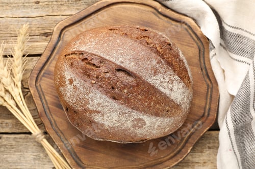 Preview: Loaf of fresh bread and spikes on wooden table, flat lay