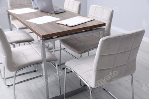 Preview: Stylish chairs and wooden table in office, closeup