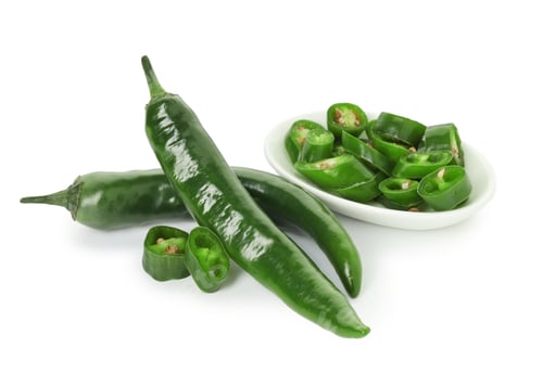 Preview: Whole and cut green chili peppers isolated on white