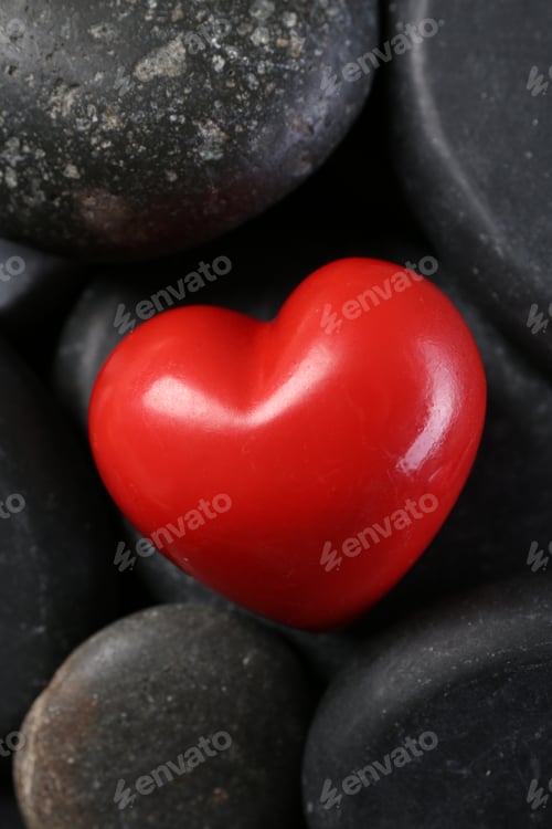 Preview: Red decorative heart on pebble stones, above view