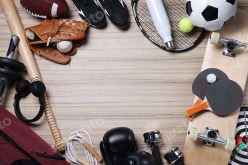 Preview: Different sports equipment, bag and headphones on wooden surface, flat lay. Space for text