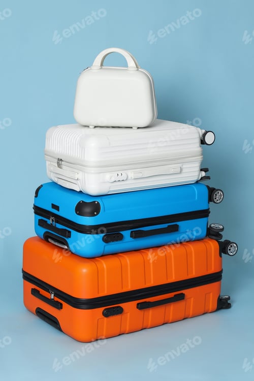 Preview: Many different stylish suitcases on light blue background