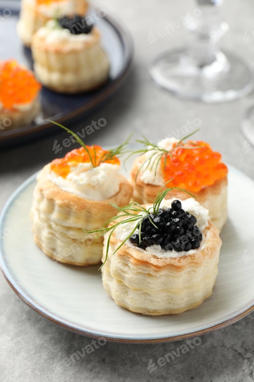 Preview: Tasty puff pastries with cream cheese, caviar and dill on grey table, closeup