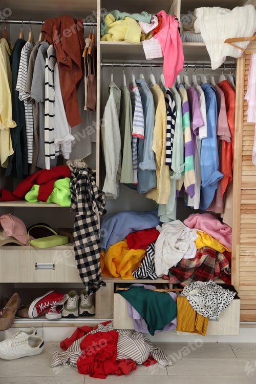 Preview: Many different messy clothes in wardrobe indoors