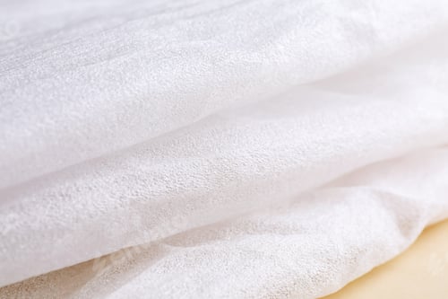 Preview: Polyethylene foam packaging on beige background, closeup