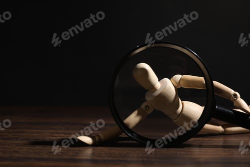Preview: Mannequin with magnifying glass on wooden table against black background, closeup. Space for text
