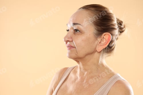 Preview: Senior woman with healthy skin on beige background, space for text