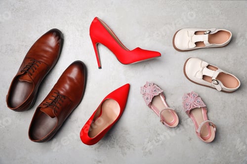 Preview: Different beautiful shoes on grey textured floor, flat lay
