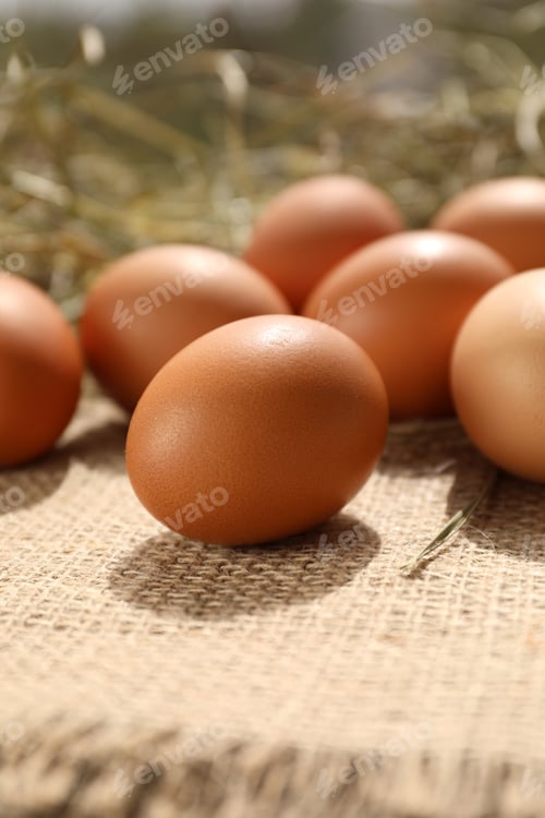 Preview: Fresh chicken eggs on burlap fabric, closeup