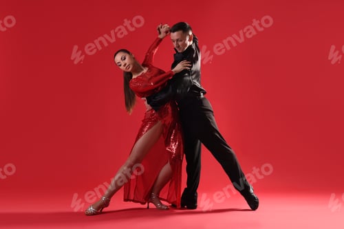 Preview: Couple of professional dancers on red background