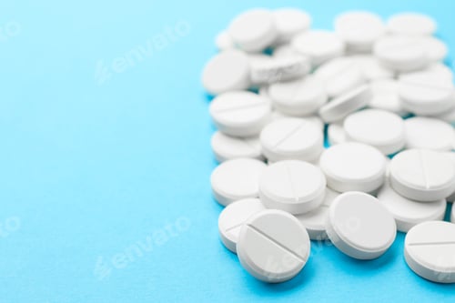 Preview: Pile of pills on light blue background, closeup. Space for text