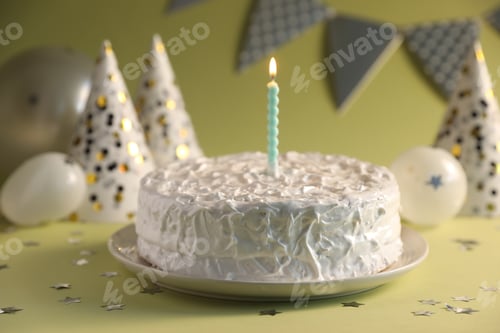 Preview: Tasty cake with burning candle on green background, closeup