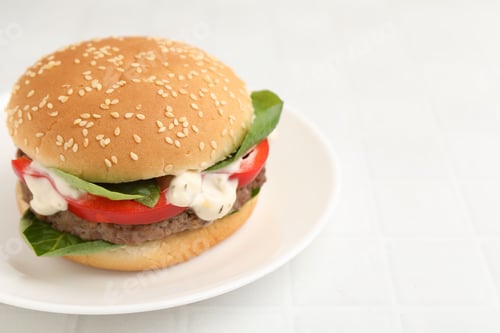 Preview: Delicious burger with meat patty on white tiled table, closeup. Space for text