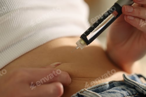 Preview: Diabetes. Woman making insulin injection into her belly with autoinjector indoors, closeup
