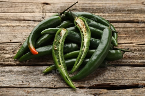 Preview: Fresh green chili peppers on wooden table, closeup