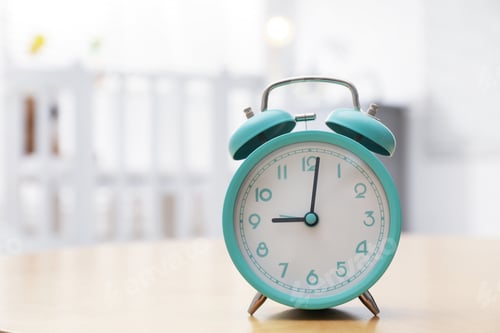 Preview: Alarm clock on table in nursery, closeup. Space for text