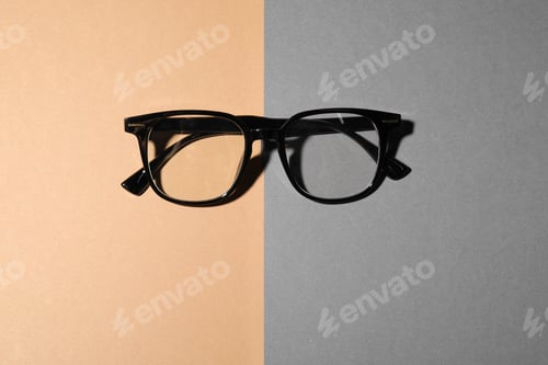 Preview: Pair of eyeglasses on color background, top view