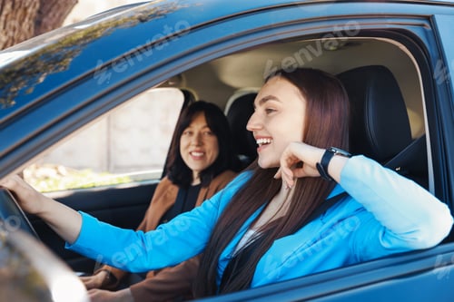 Preview: Happy women riding car together, view through window