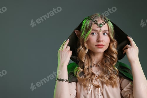 Preview: Beautiful girl dressed as elf on grey background, space for text