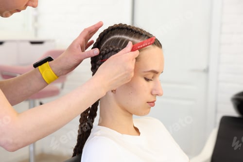 Preview: Hair braiding. Hairdresser working with teenage girl in salon, closeup