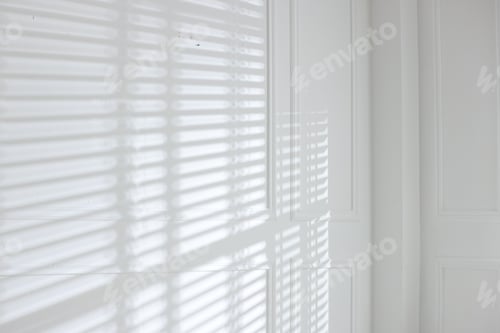 Preview: Light and shadows from window blinds falling on white wall