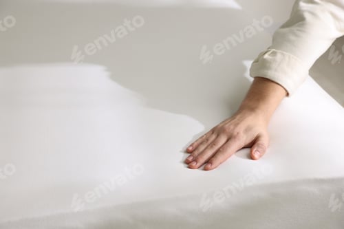 Preview: Man touching white soft mattress, closeup view