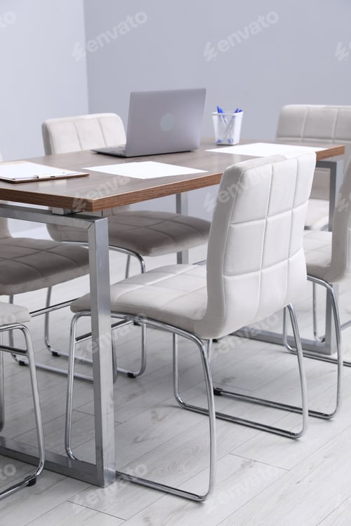 Preview: Stylish chairs and wooden table in office